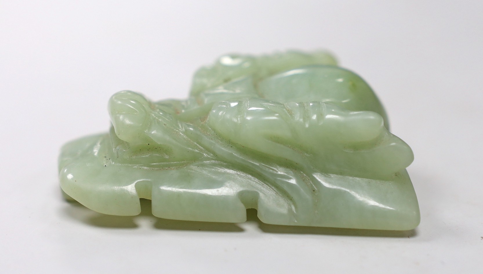 A Chinese bowenite jade dragon’s head belt buckle. 7cm wide